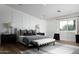 Bright bedroom featuring neutral color palette, wainscoting, and a comfortable bed with stylish furnishings at 6302 E Hillcrest Blvd, Scottsdale, AZ 85251