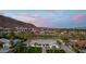 Stunning exterior view of a luxury home surrounded by lush greenery and palm trees against a scenic mountain backdrop at 6302 E Hillcrest Blvd, Scottsdale, AZ 85251