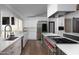 Modern kitchen featuring stainless steel appliances, white cabinets, and wood floors at 6302 E Hillcrest Blvd, Scottsdale, AZ 85251