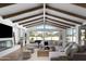 Spacious living room with vaulted ceilings, hardwood floors, and a sectional sofa at 6302 E Hillcrest Blvd, Scottsdale, AZ 85251