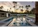 Beautiful backyard pool area with palm trees and modern outdoor lounge furniture at 6302 E Hillcrest Blvd, Scottsdale, AZ 85251