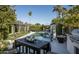 Backyard pool area with outdoor dining, lush landscaping, and palm trees at 6531 N 81St Pl, Scottsdale, AZ 85250