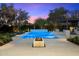 Backyard swimming pool with a raised spa, a waterfall feature, a fire pit, and mature landscaping at 6651 E Horseshoe Rd, Paradise Valley, AZ 85253