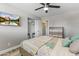 Comfortable bedroom features a TV, ceiling fan, and wood-look tile flooring at 8102 E Indianola Ave, Scottsdale, AZ 85251