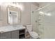 Bathroom featuring a vanity and tiled shower with glass door and built-in shelves at 8134 E Obispo Ave, Mesa, AZ 85212