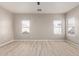 Bright bedroom with neutral walls, wood-look floors, and natural light from the windows at 8134 E Obispo Ave, Mesa, AZ 85212