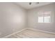 Small bedroom featuring neutral walls, wood-look floors, and a window at 8134 E Obispo Ave, Mesa, AZ 85212