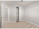 Bedroom with closet, neutral walls, and light wood grain vinyl floors at 8134 E Obispo Ave, Mesa, AZ 85212