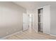 Bedroom featuring wood-look floors, closet, and neutral color palette at 8134 E Obispo Ave, Mesa, AZ 85212
