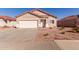 Well-maintained single-story home with a two-car garage, tile roof, and desert landscaping at 8134 E Obispo Ave, Mesa, AZ 85212