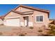 Single-story home with a tile roof, desert landscaping, and a two-car garage at 8134 E Obispo Ave, Mesa, AZ 85212