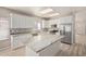 Bright kitchen features white cabinets, stainless steel appliances, and large island with stone countertop at 8134 E Obispo Ave, Mesa, AZ 85212