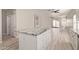 Kitchen island with granite countertop and white cabinets overlooking the living area at 8134 E Obispo Ave, Mesa, AZ 85212