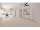 Spacious living room with wood-look floors, ceiling fans, and a view into the kitchen at 8134 E Obispo Ave, Mesa, AZ 85212