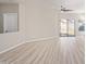 Bright living room with modern flooring and natural light from the sliding glass door at 8134 E Obispo Ave, Mesa, AZ 85212