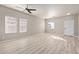 Spacious, bright living room with ceiling fan and modern flooring, filled with natural light at 8134 E Obispo Ave, Mesa, AZ 85212