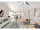 Open-concept living room and kitchen area with modern furnishings and light wood-style floors at 8134 E Obispo Ave, Mesa, AZ 85212