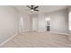 Primary bedroom with ensuite bathroom and walk-in closet featuring neutral walls and wood-look floors at 8134 E Obispo Ave, Mesa, AZ 85212