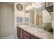 Bathroom featuring a large mirror, granite countertop, and a walk-in shower at 8442 N 18Th St, Phoenix, AZ 85020