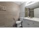 Updated bathroom features sleek tile walls, modern fixtures, and a stylish vanity with plenty of storage at 8534 W Salter Dr, Peoria, AZ 85382