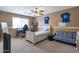 Neutral bedroom featuring carpet, ceiling fan, and a desk and couch area at 8534 W Salter Dr, Peoria, AZ 85382