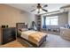 Cozy bedroom featuring carpet, ceiling fan, reading nook and contemporary furniture at 8534 W Salter Dr, Peoria, AZ 85382