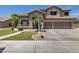 Two-story home featuring desert landscaping, a tile roof, and a two-car garage at 8534 W Salter Dr, Peoria, AZ 85382