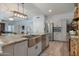 Updated kitchen boasts stainless appliances, granite countertops, and a spacious stainless sink and faucet at 8534 W Salter Dr, Peoria, AZ 85382