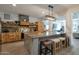 Spacious kitchen features a large granite island with seating and custom wood cabinets and shelving at 8534 W Salter Dr, Peoria, AZ 85382