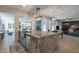 Kitchen island with granite countertop, stainless sink and pendant lighting is perfect for gathering and entertaining at 8534 W Salter Dr, Peoria, AZ 85382