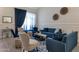 Cozy living room with blue accents, decorative wall hangings, and ample natural light at 8534 W Salter Dr, Peoria, AZ 85382