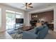 Inviting living room with sliding glass doors and brick wall is perfect for relaxing or entertaining guests at 8534 W Salter Dr, Peoria, AZ 85382