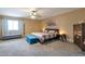 Bright and airy main bedroom features plush carpeting, a ceiling fan and furniture for relaxing at 8534 W Salter Dr, Peoria, AZ 85382