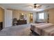 Large main bedroom with neutral walls, ceiling fan, and ensuite bathroom with tiled shower and barn door at 8534 W Salter Dr, Peoria, AZ 85382