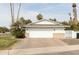 Detached two-car garage featuring a brick paver driveway and manicured landscaping at 8708 E Sells Dr, Scottsdale, AZ 85251