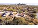 Residential home featuring desert landscaping, community pool, mountain views, and lush landscape at 9200 E Whitethorn Cir # 601, Scottsdale, AZ 85266