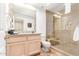 Stylish bathroom features a glass enclosed shower, vanity with granite countertop, and tiled floors at 9200 E Whitethorn Cir # 601, Scottsdale, AZ 85266