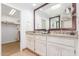 Bright bathroom features a double sink vanity with granite countertop and walk-in closet at 9200 E Whitethorn Cir # 601, Scottsdale, AZ 85266