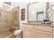 Bright bathroom features a glass enclosed shower, vanity with granite countertop, and tiled floors at 9200 E Whitethorn Cir # 601, Scottsdale, AZ 85266