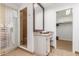 Bright bathroom features a glass enclosed shower, vanity with granite countertop, and walk-in closet at 9200 E Whitethorn Cir # 601, Scottsdale, AZ 85266