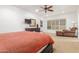 Bright bedroom featuring a ceiling fan, shutters, and neutral carpet at 9200 E Whitethorn Cir # 601, Scottsdale, AZ 85266