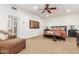 Comfortable bedroom with neutral carpet, ceiling fan, and ample space at 9200 E Whitethorn Cir # 601, Scottsdale, AZ 85266