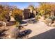 Inviting home featuring desert landscaping, a two-car garage, and a private driveway at 9200 E Whitethorn Cir # 601, Scottsdale, AZ 85266