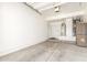 Spacious two-car garage interior with ample storage space and access door at 9200 E Whitethorn Cir # 601, Scottsdale, AZ 85266