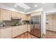 Well-equipped kitchen with stainless steel refrigerator, stone backsplash, and abundant cabinet space at 9200 E Whitethorn Cir # 601, Scottsdale, AZ 85266