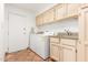 Functional laundry room with updated washer and dryer and tile floors at 9200 E Whitethorn Cir # 601, Scottsdale, AZ 85266