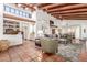 Open-concept living room featuring high ceilings, exposed beams, and terracotta tile flooring at 9200 E Whitethorn Cir # 601, Scottsdale, AZ 85266