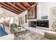Inviting living room featuring a fireplace, exposed beam ceiling, and charming Southwestern decor at 9200 E Whitethorn Cir # 601, Scottsdale, AZ 85266