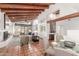 Bright living room featuring high ceilings, exposed beams, and terracotta tile flooring at 9200 E Whitethorn Cir # 601, Scottsdale, AZ 85266