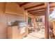Well-equipped covered patio with a built-in stainless steel grill and comfortable seating at 9200 E Whitethorn Cir # 601, Scottsdale, AZ 85266